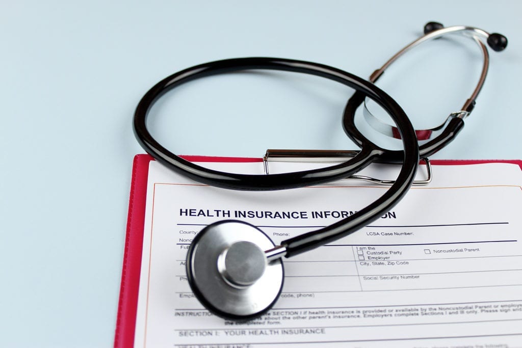health insurance claim form and stethoscope